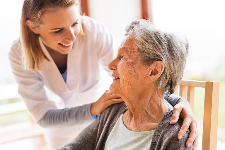 Nurse taking care of an elderly woman.