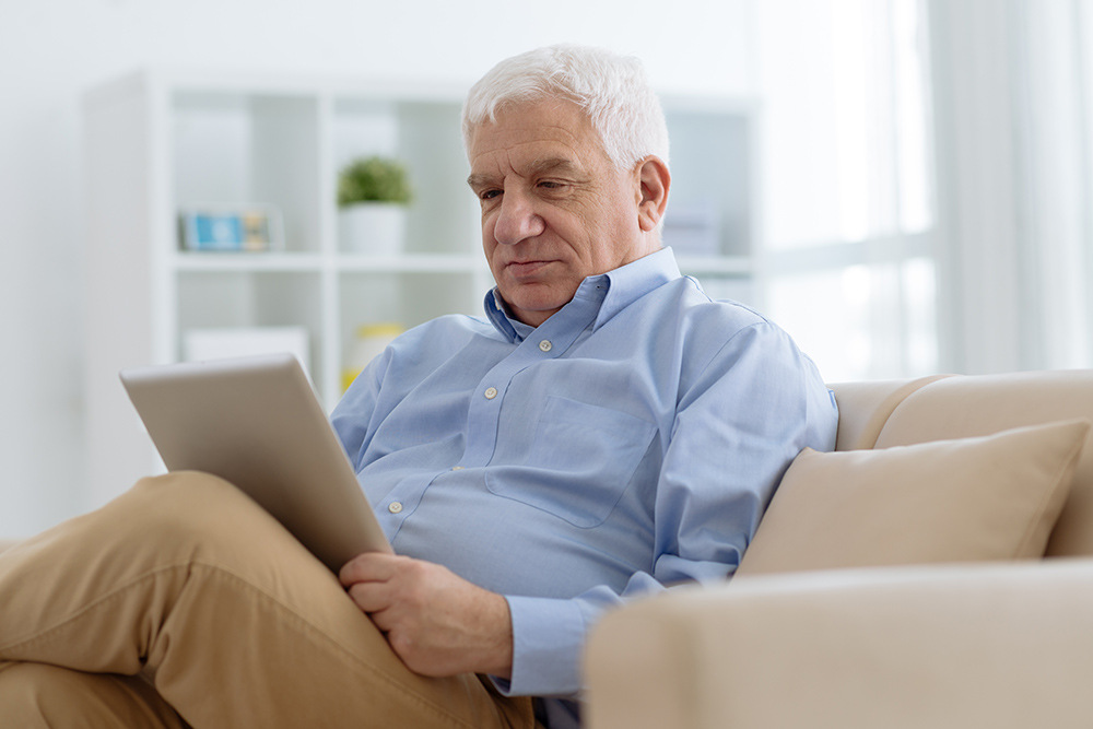 Elderly man reading a book.