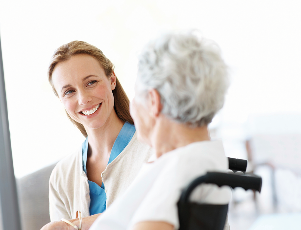 Nurse with elderly woman in wheelchair.